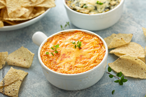 Photography Buffalo chicken dip served with chips and fresh vegetables