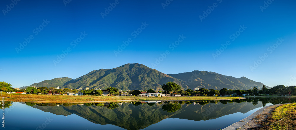 Panoramic view of a sunrise at Parque del Este with El Avila at the background