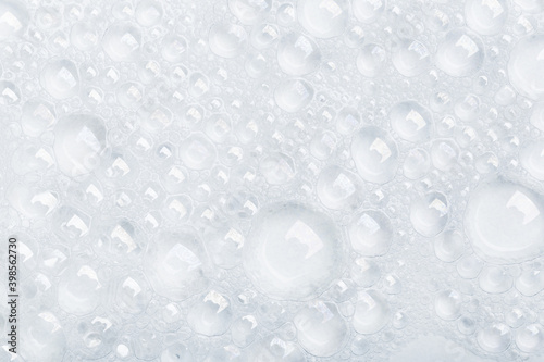 Background of soap foam and bubbles on a white background  macro photography