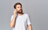 handsome guy in headphones on gray background white t-shirt emotions model