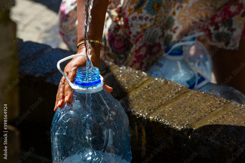 People collecting natural spring water in drought water crisis with 5