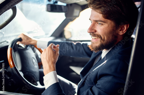 Cheerful business man in a suit driving a car trip passenger road © SHOTPRIME STUDIO
