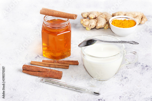 Healthy natural food for the treatment of flu and colds. Honey, milk, ginger and cinnamon to strengthen the immune system, protect against viruses, folk alternative medicine, selective focus.