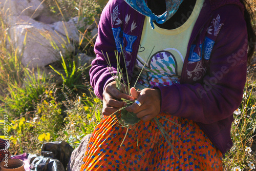 Woman of Tarahumara origin making Mexican crafts photo