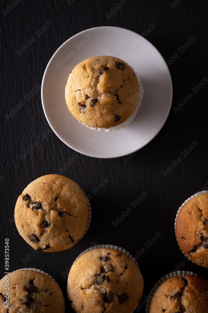 muffins with chocolate chips seen from above on a dark background muffins with chocolate chips seen from above on a dark background