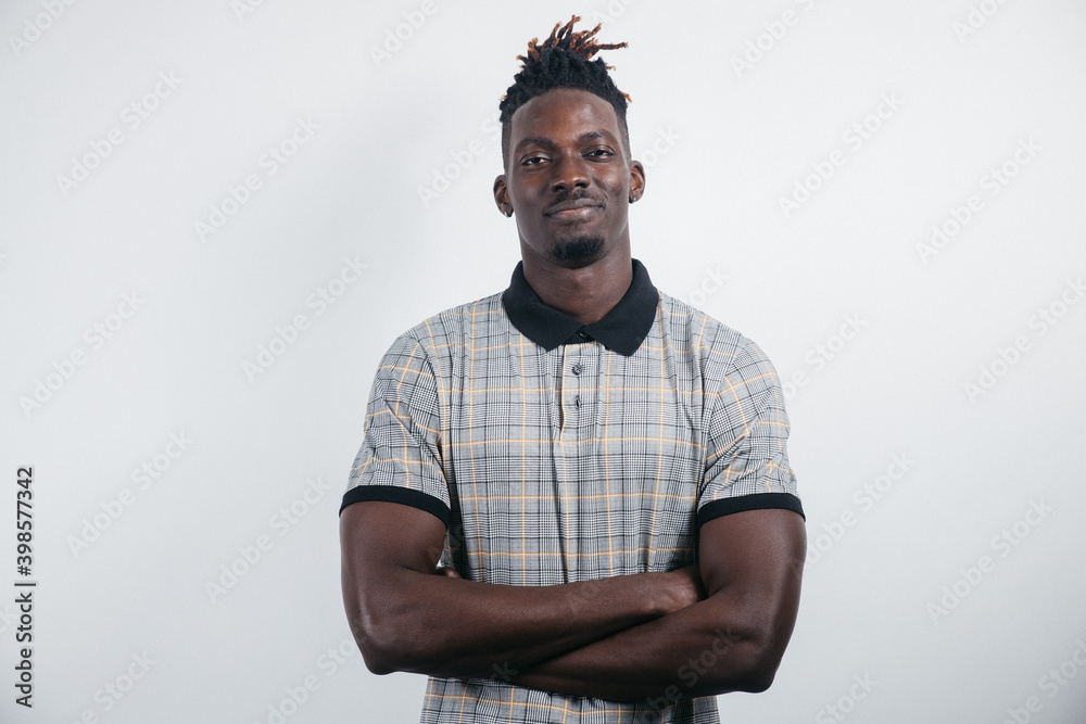 Smiling African-American millennial businessman, student isolated on a light Studio background posing, satisfied successful black man in formal suit looks at the camera laughing Smiling African-American millennial businessman, student isolated on a light Studio background posing, satisfied successful black man in formal suit looks at the camera laughing