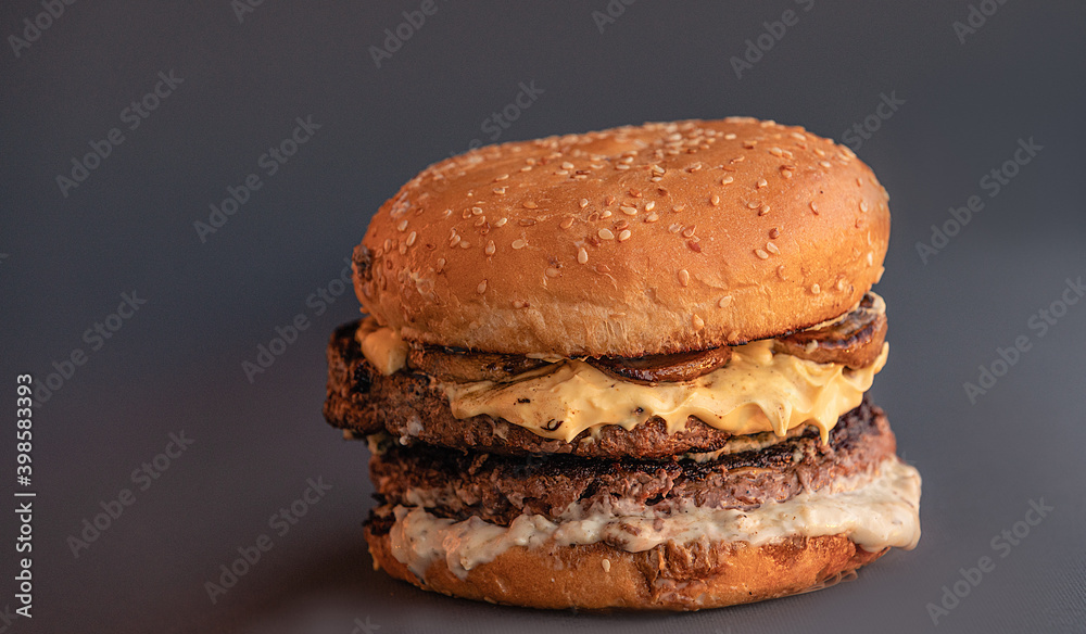 Close-up of home made burgers. Brown wooden background. Close-up of home made burgers. Brown wooden background.
