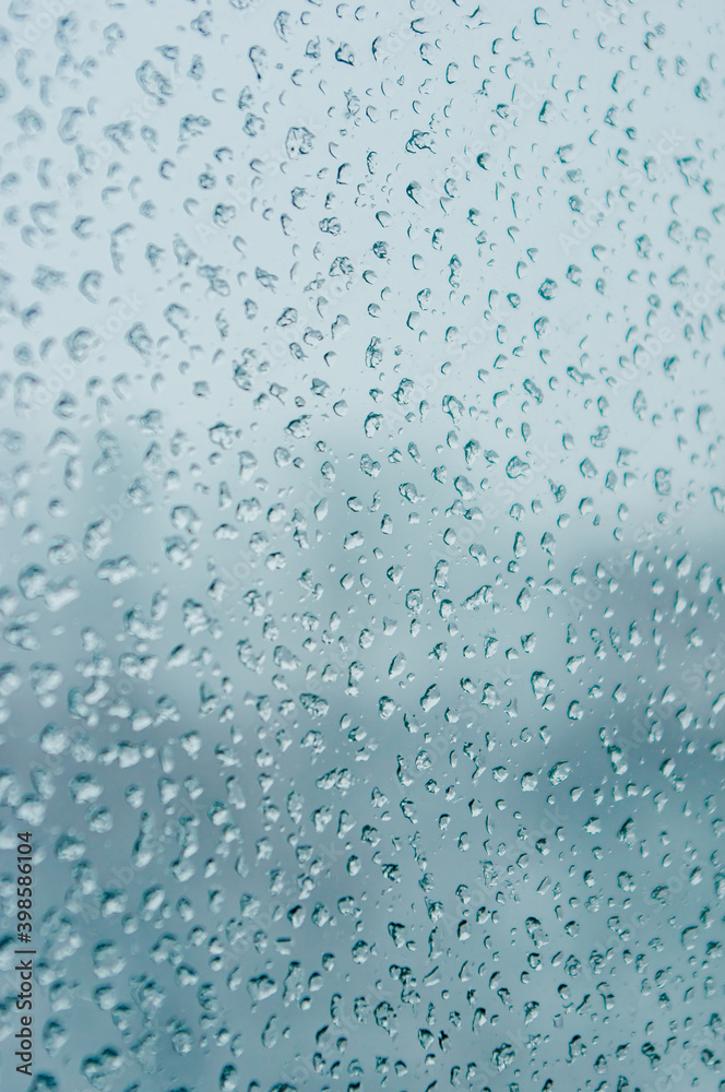 Melting snow on the glass, drops of water condensation on the window, and transparent glass of the window in cold winter, winter landscape outside the window, close-up. Melting snow on the glass, drops of water condensation on the window, and transparent glass of the window in cold winter, winter landscape outside the window, close-up.