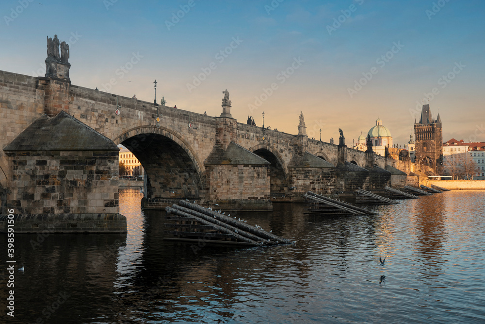 .stones charles bridge over vltava river and blue sky at sunset in the center of prague