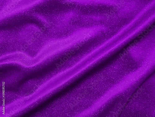 Shiny purple crumpled fabric texture. Elegant wavy cloth background