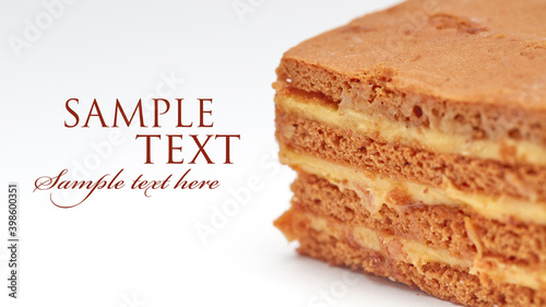 close-up of a piece of honey cake on a white isolated background