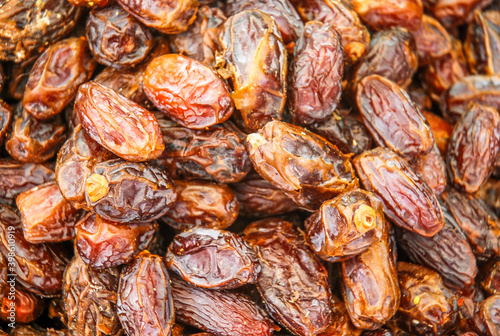 Background with close up of dried fruit - brown dates on a stall