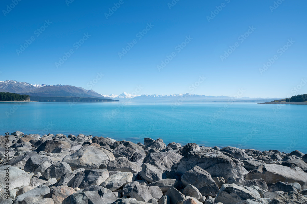 Lake Pukaki bright blue with distant Souther Alps and Mount Cook Lake Pukaki bright blue with distant Souther Alps and Mount Cook