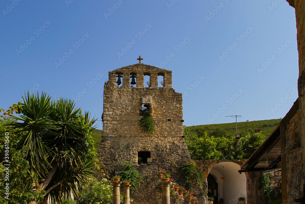 Stone bell tower of an ancient Orthodox church on the Peloponnese island (Greece) Stone bell tower of an ancient Orthodox church on the Peloponnese island (Greece)
