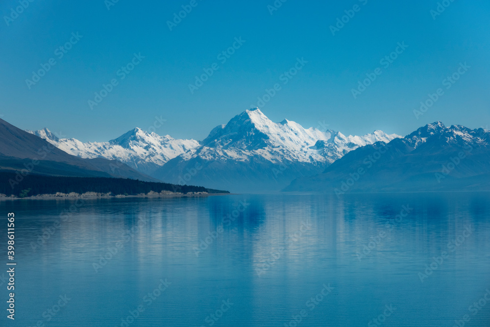 shoreline and view across Lake Pukaki with Mount Cook and Southern Alps in distance.