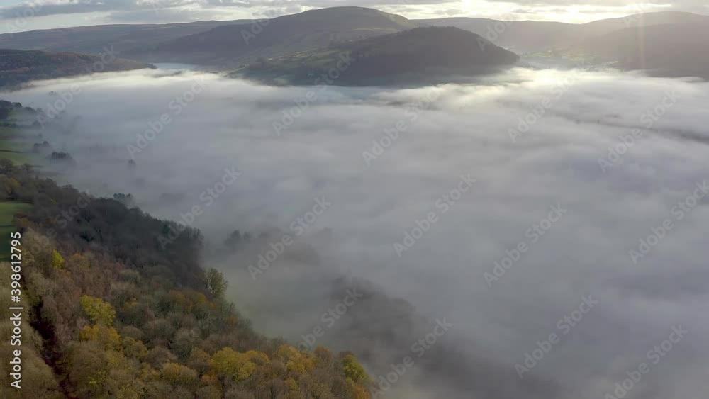 Aerial view of a green rural valley filled with low hanging fog and mist (Powys, Wales) Aerial view of a green rural valley filled with low hanging fog and mist (Powys, Wales)