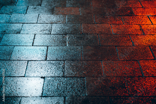 Red and blue light falling on the wet ground photo