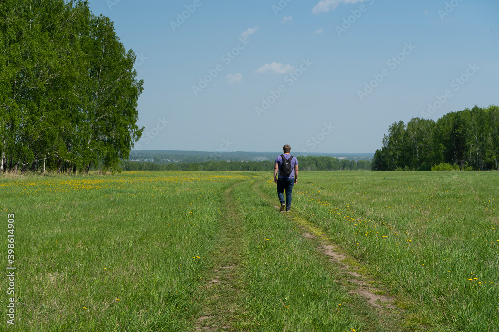 A man walks on a rural road A man walks on a rural road