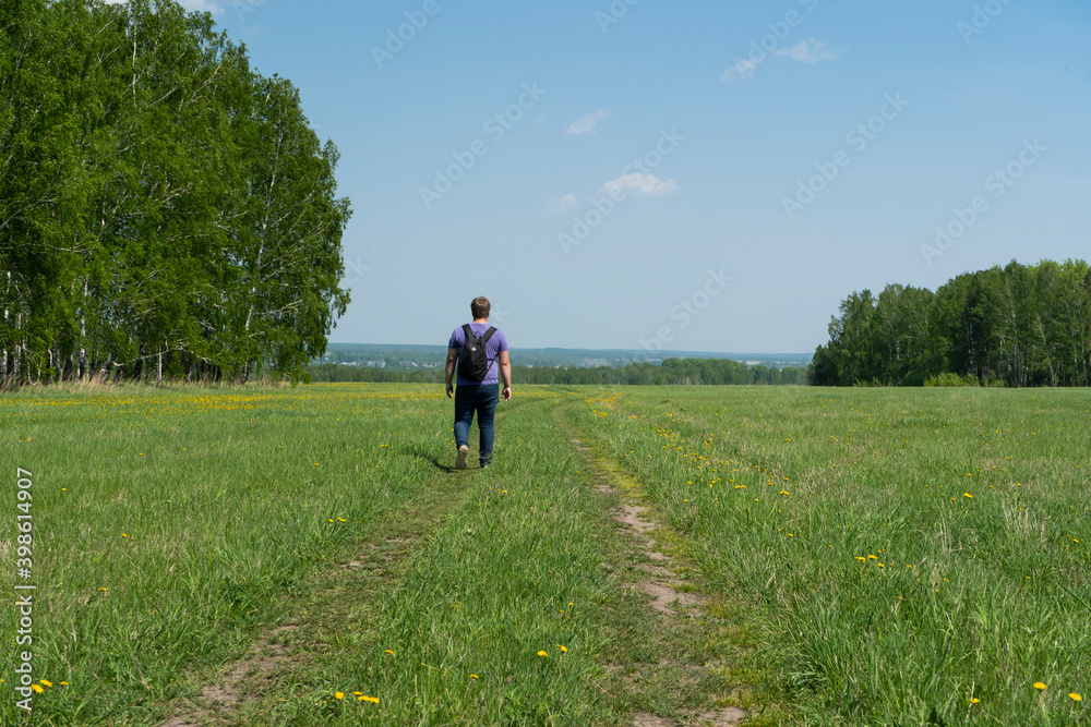 A man walks on a rural road