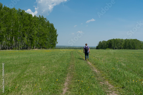 A man walks on a rural road