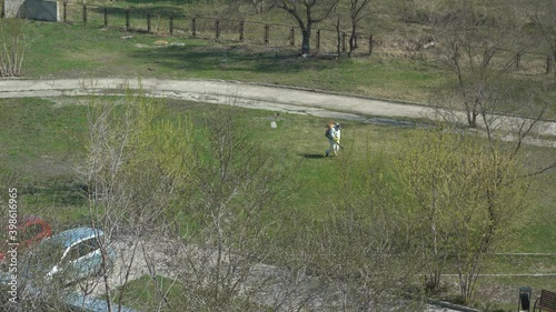 A man in a white protective suit handles the territory from COVID-19