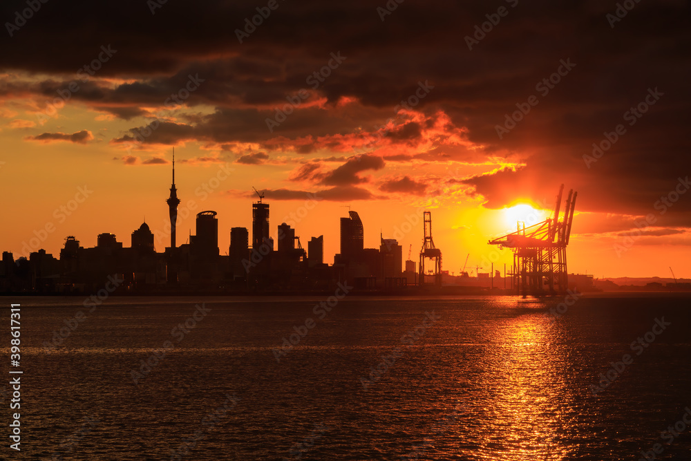The skyline of Auckland, New Zealand, silhouetted at sunset