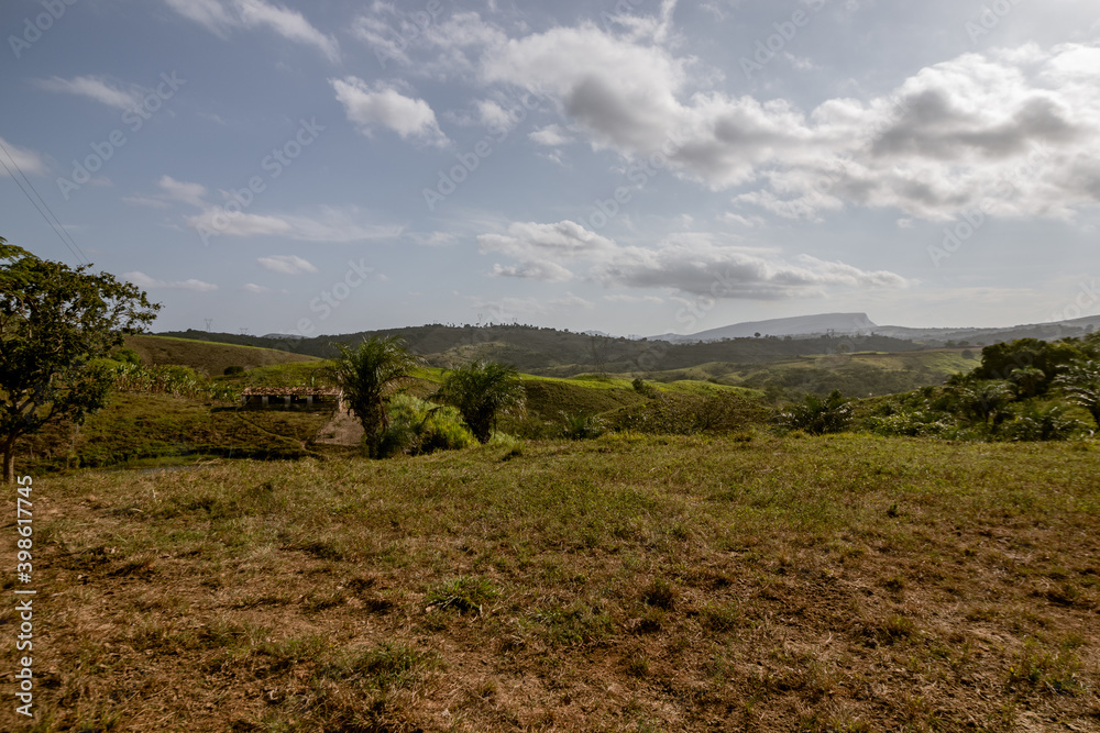 Rural landscape with hills and mountains in the background and typical vegetation of the Brazilian Northeast