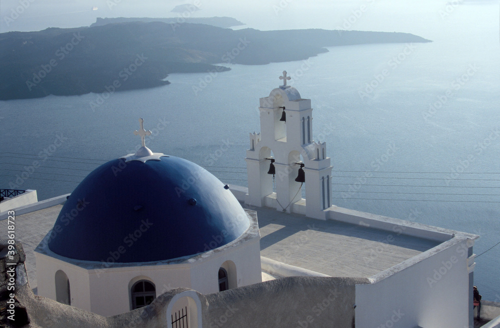 View of Santorini blue domed church and Church bells with  caldera in Santorini, Greece. 