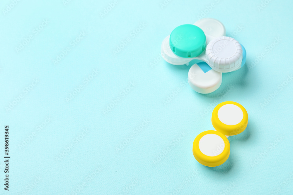 Containers with contact lenses on color background Containers with contact lenses on color background
