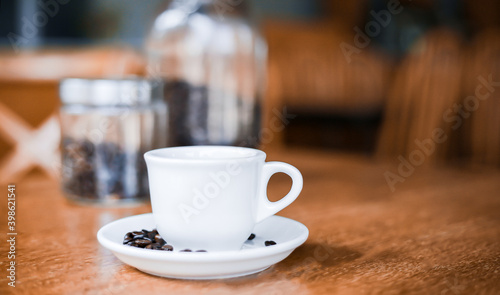 Coffee cup and saucer on a wooden table. Dark background.