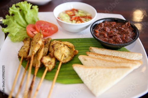 Islamic food, chicken satay with bread and dipping sauce