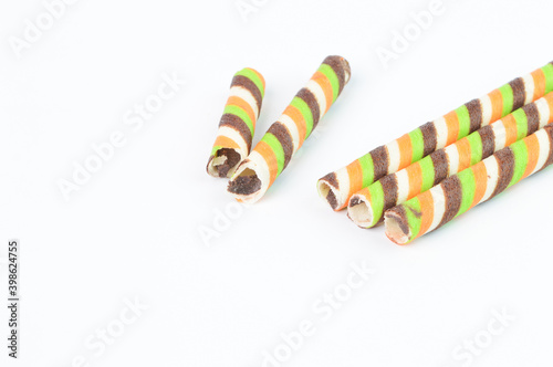 Biscuit sticks with chocolate stripes on a white background