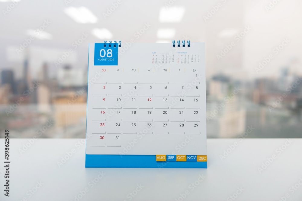 White Calendar of August on the white table with city view background White Calendar of August on the white table with city view background