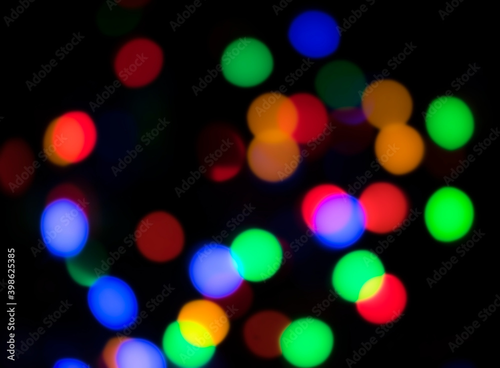 Multicolored holiday lights out of focus background