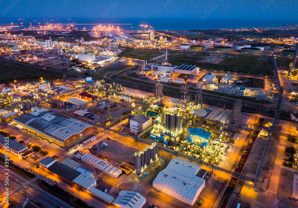Fototapeta premium Industrial background with modern large chemical factory at night, Salou, Spain