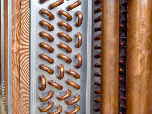 Close up shot of copper plain tubes of a condenser coil.	
 photo