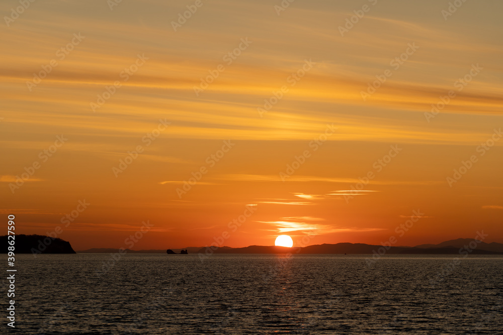 Seascape with a beautiful sunset on the horizon.