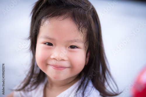 Cute child sweet smile. Head shot. Girl aged 3 years old.