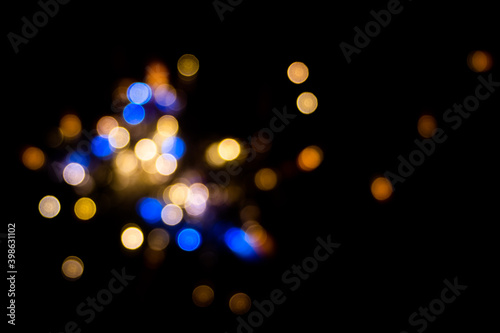 Perfect bokeh for a festive New Year and Christmas background. Defocused abstract yellow and blue light