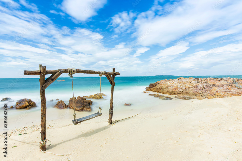 Beautiful tropical beach. wooden swing and white sand in summer day at sea beach. Beautiful tropical beach. wooden swing and white sand in summer day at sea beach.