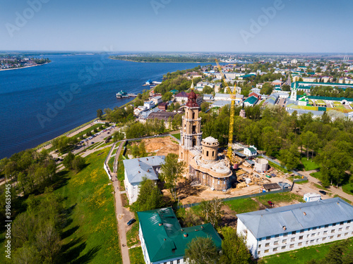 Aerial view of Kostroma city on bank of Volga River overlooking Temple Complex of Kostroma Kremlin during reconstruction, Russia