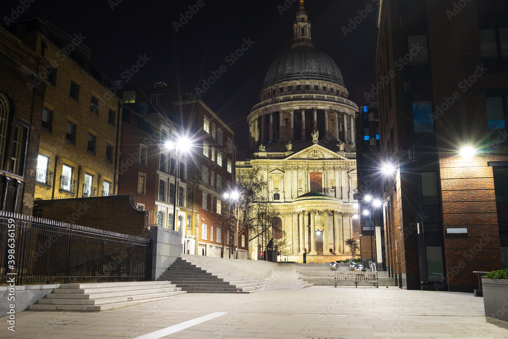 St. Paul's cathedral at night viewed from Sermon Lane in London. England