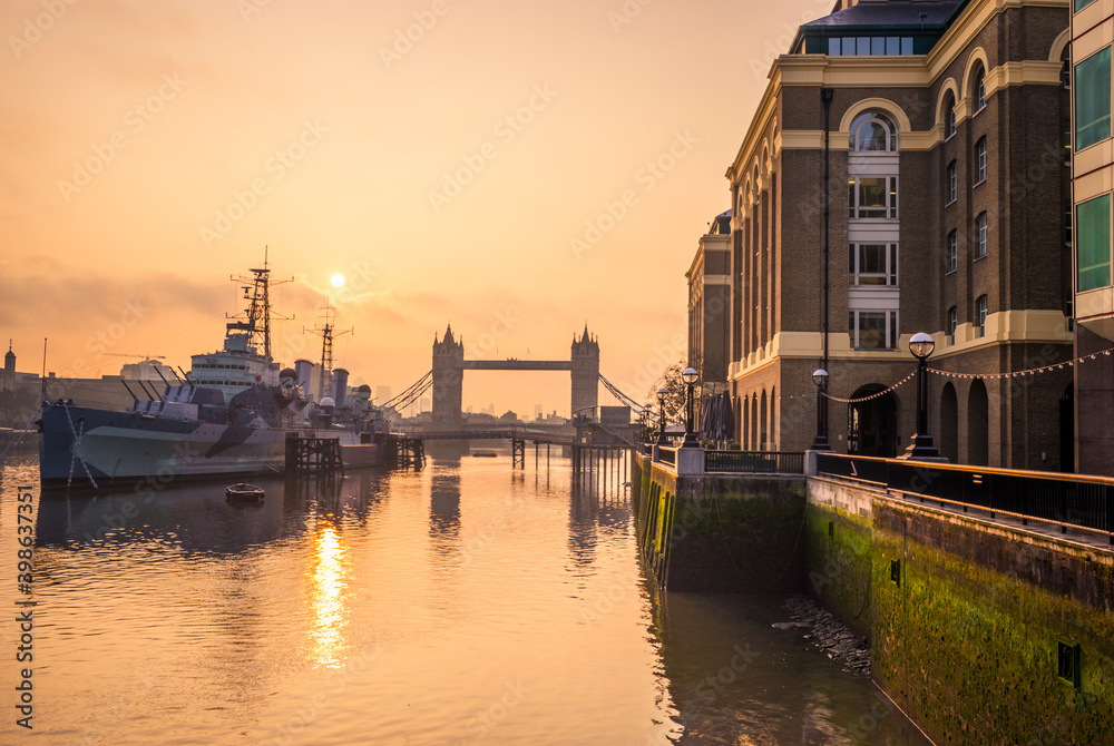 Tower Bridge at sunrise seen from the southbank promenade in London. England
