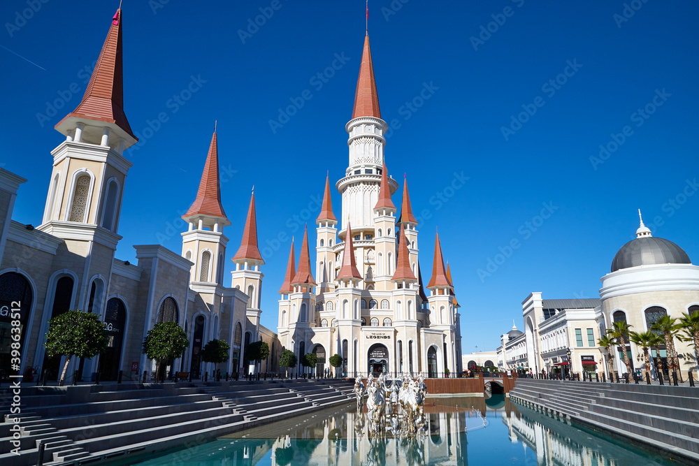 Fototapeta premium Belek, Turkey - December 17, 2019: Main pool with statues and nice castle in Land of Legends theme mall. Night. A very big hotel, shopping mall and fun park located in Belek, Antalya, Turkey.
