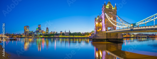 Panorama of Tower Bridge and skyscrapers of financial district at dusk