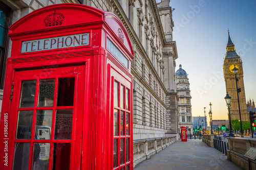 Red telephone both near Big Ben at sunrise. London  Great Britain 