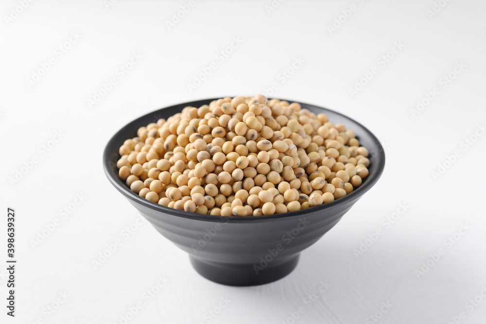 Soybeans seed in a black bowl on white background Soybeans seed in a black bowl on white background