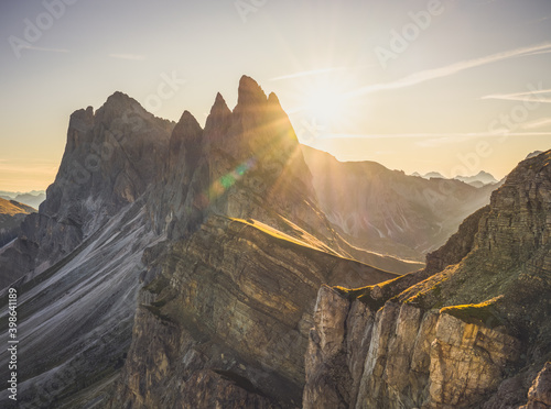 Amazing misty sunrise of Seceda peak with sun flare. Trentino Alto Adige, Dolomites Alps, South Tyrol, Italy, Europe