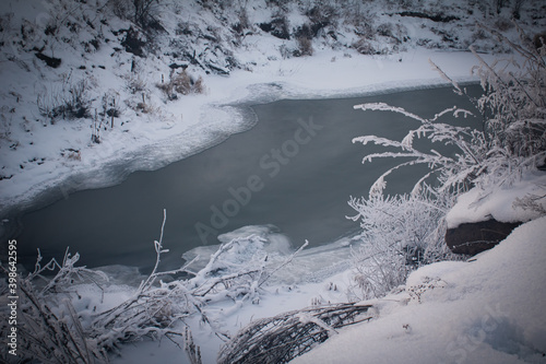 Bild auf Leinwand ice-bound river in the lowlands and snow-covered banks