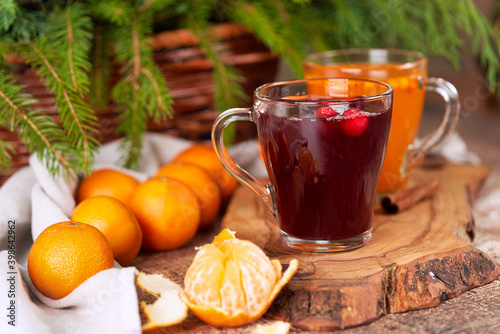 Tangerines and mulled wine in transparent mugs on the christmas table
